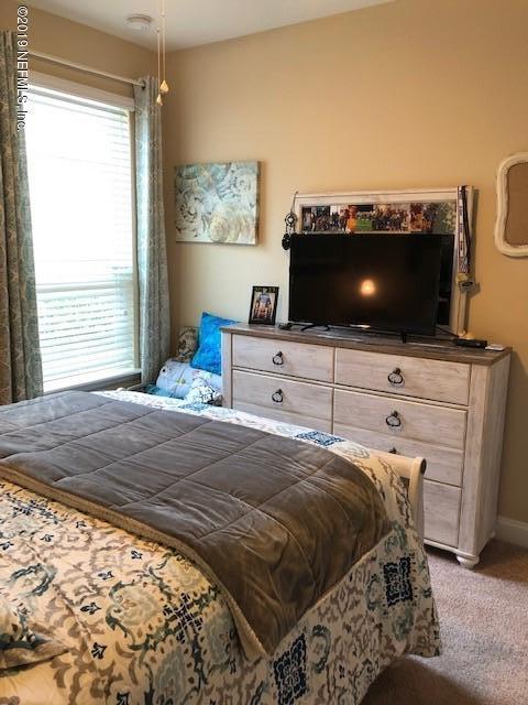 188 Antilles Road St. Augustine, FL 32092 - Photo 19 of 43 a bedroom with a bed and flat screen tv