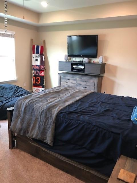 188 Antilles Road St. Augustine, FL 32092 - Photo 24 of 43 a bedroom with a bed and a flat screen tv