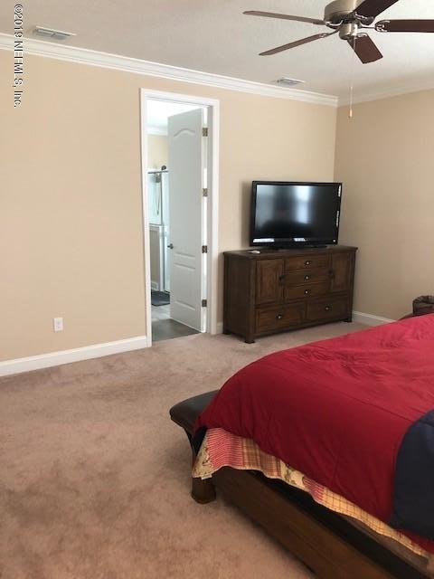 188 Antilles Road St. Augustine, FL 32092 - Photo 25 of 43 a bedroom with a bed and a flat screen tv