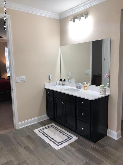 188 Antilles Road St. Augustine, FL 32092 - Photo 30 of 43 a bathroom with a sink vanity and mirror