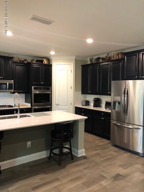 188 Antilles Road St. Augustine, FL 32092 - Photo 3 of 43 a kitchen with stainless steel appliances wooden cabinets a refrigerator and a sink