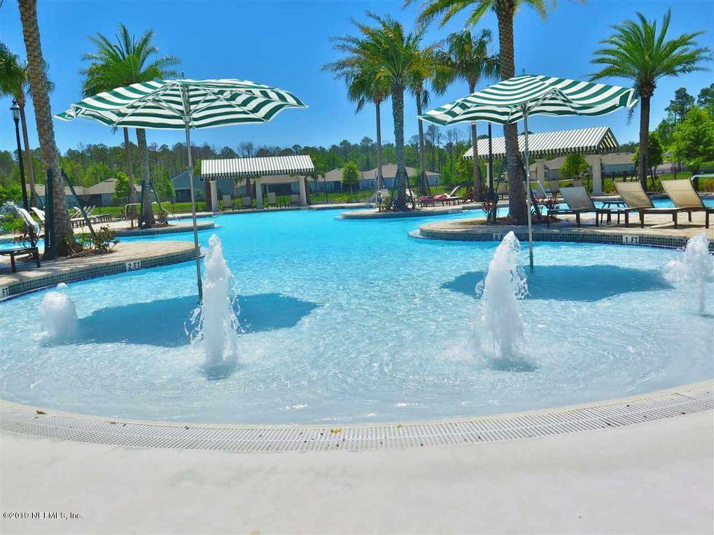 188 Antilles Road St. Augustine, FL 32092 - Photo 38 of 43 a view of a swimming pool with a lawn chair and palm tree