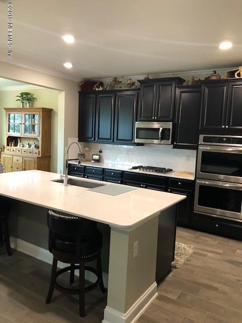 188 Antilles Road St. Augustine, FL 32092 - Photo 5 of 43 a kitchen with kitchen island a sink counter top space and appliances