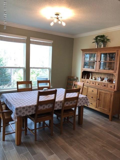 188 Antilles Road St. Augustine, FL 32092 - Photo 9 of 43 a dining room with a wooden table and chairs