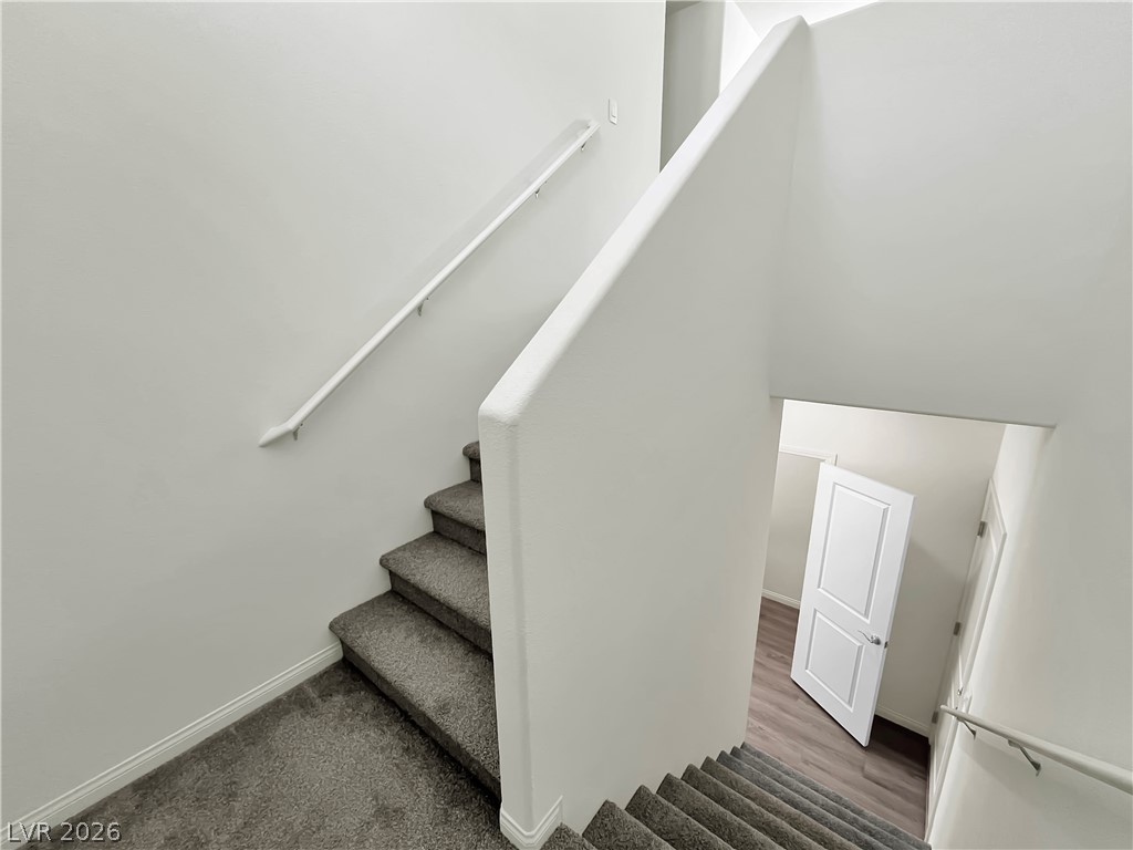 9984 Indigo Cliffs Street Las Vegas, NV 89141 - Photo 10 of 31 Stairs with baseboards and wood finished floors
