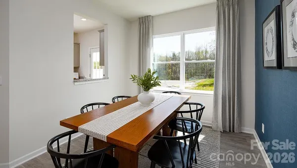 a view of a dining room with furniture and window