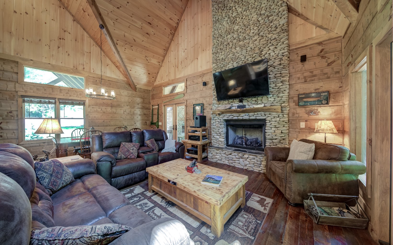 15 Kiki's River Road Blue Ridge, GA 30513 - Photo 12 of 32 a living room with furniture a flat screen tv and a fireplace