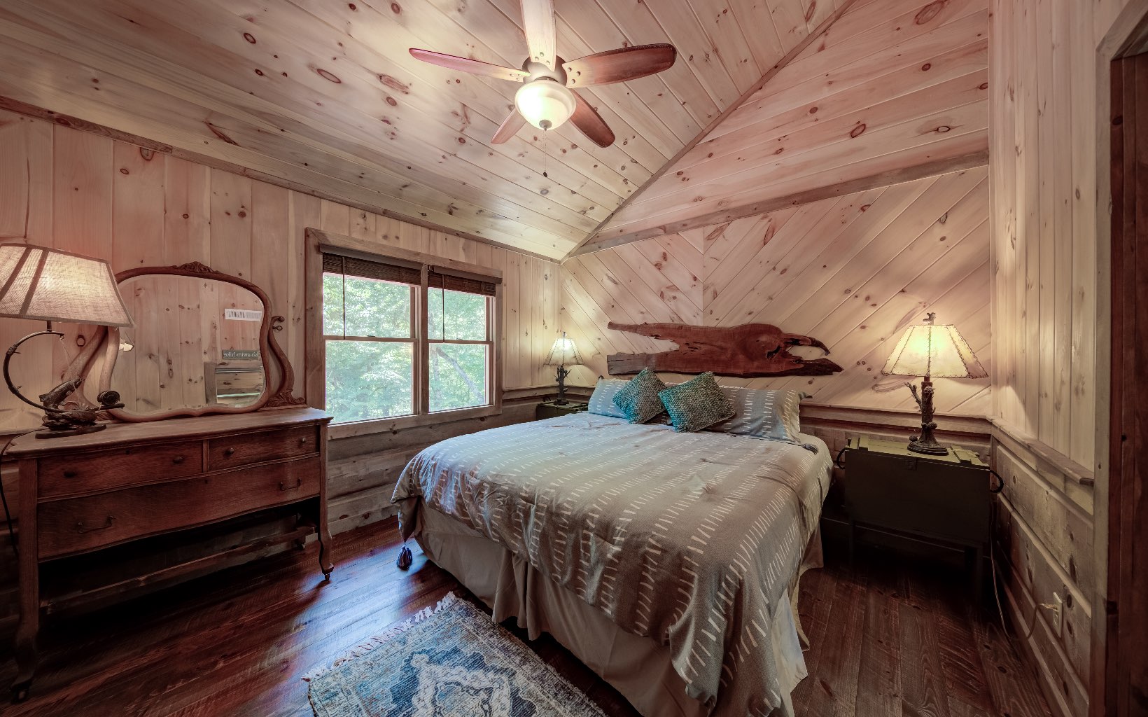 15 Kiki's River Road Blue Ridge, GA 30513 - Photo 26 of 32 a bedroom with a bed a chandelier and dresser