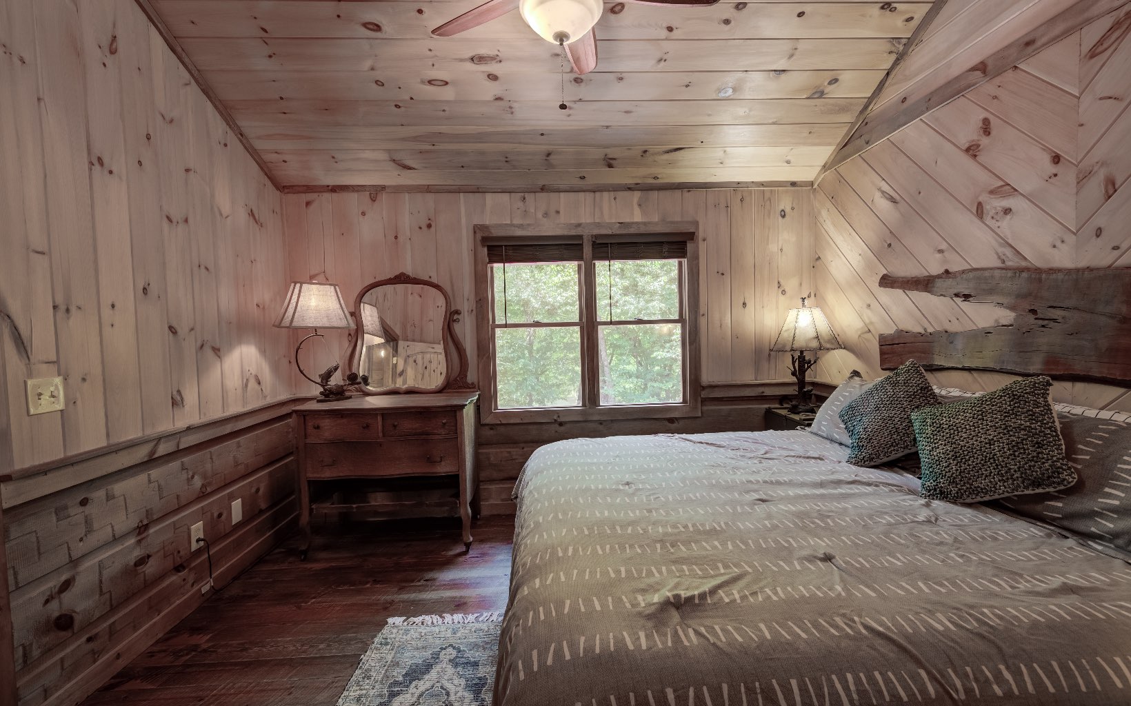 15 Kiki's River Road Blue Ridge, GA 30513 - Photo 27 of 32 a bedroom with a bed and a dresser next to a window