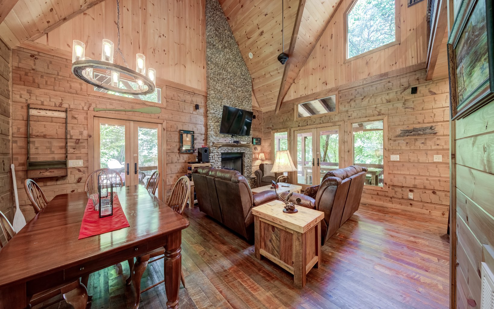 15 Kiki's River Road Blue Ridge, GA 30513 - Photo 10 of 32 a living room with furniture a fireplace and a floor to ceiling window