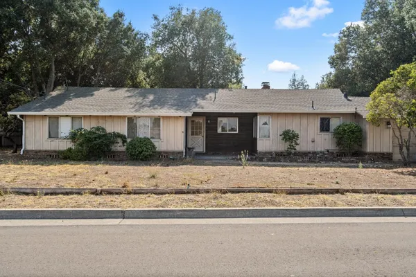 a front view of a house with a yard and a garage