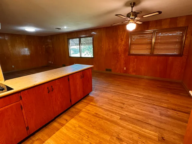 a view of a room with wooden floor and fan