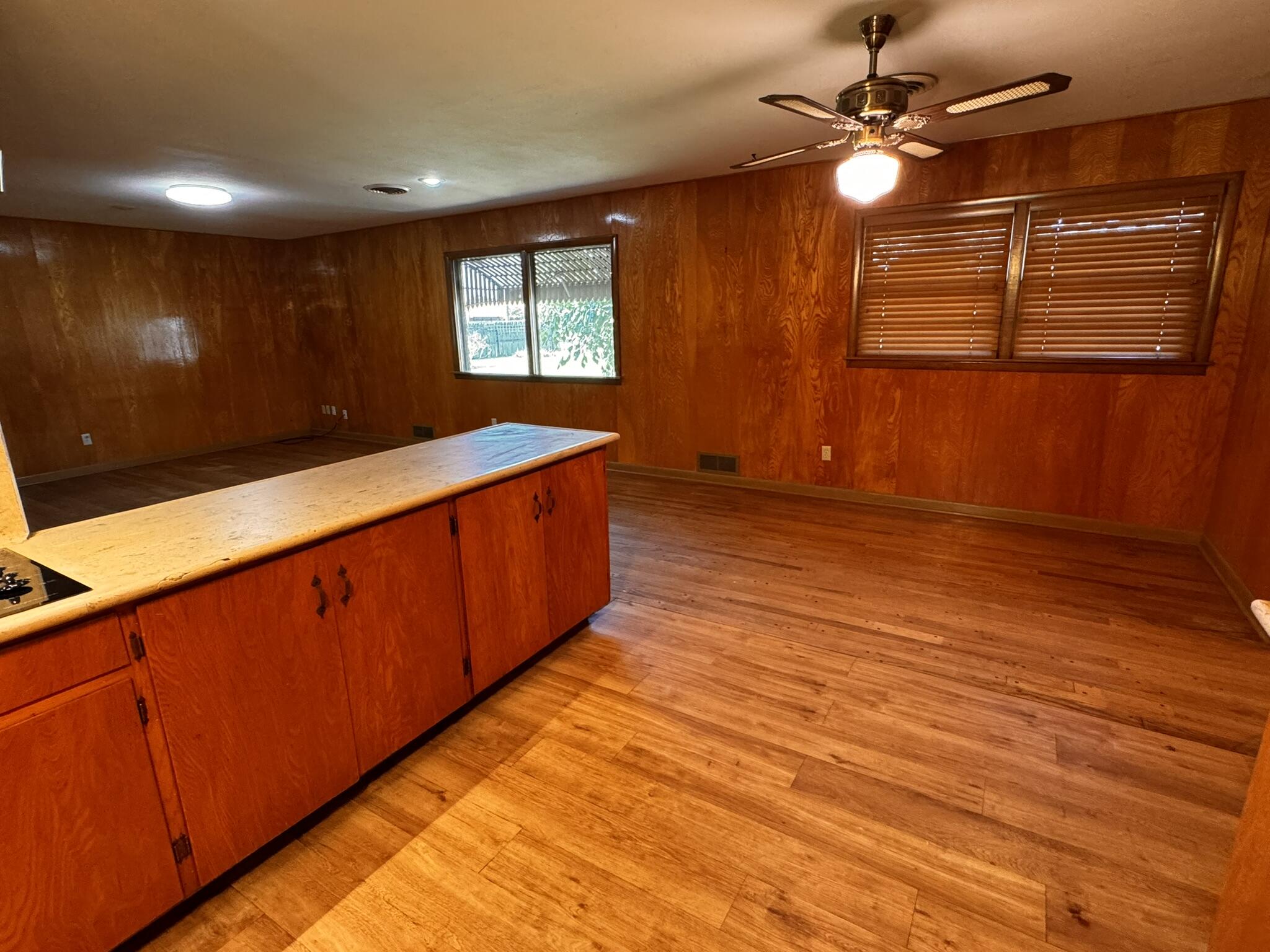 701 Zephyr Plainview, TX 79072 - Photo 13 of 29 a view of a room with wooden floor and fan