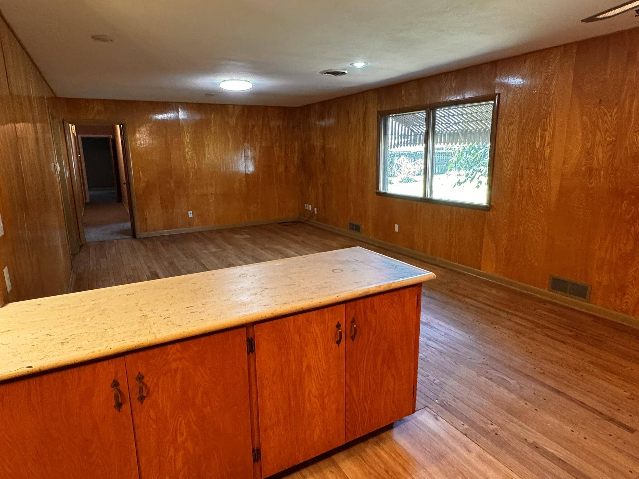 701 Zephyr Plainview, TX 79072 - Photo 15 of 29 a view of an empty room with wooden floor and a window