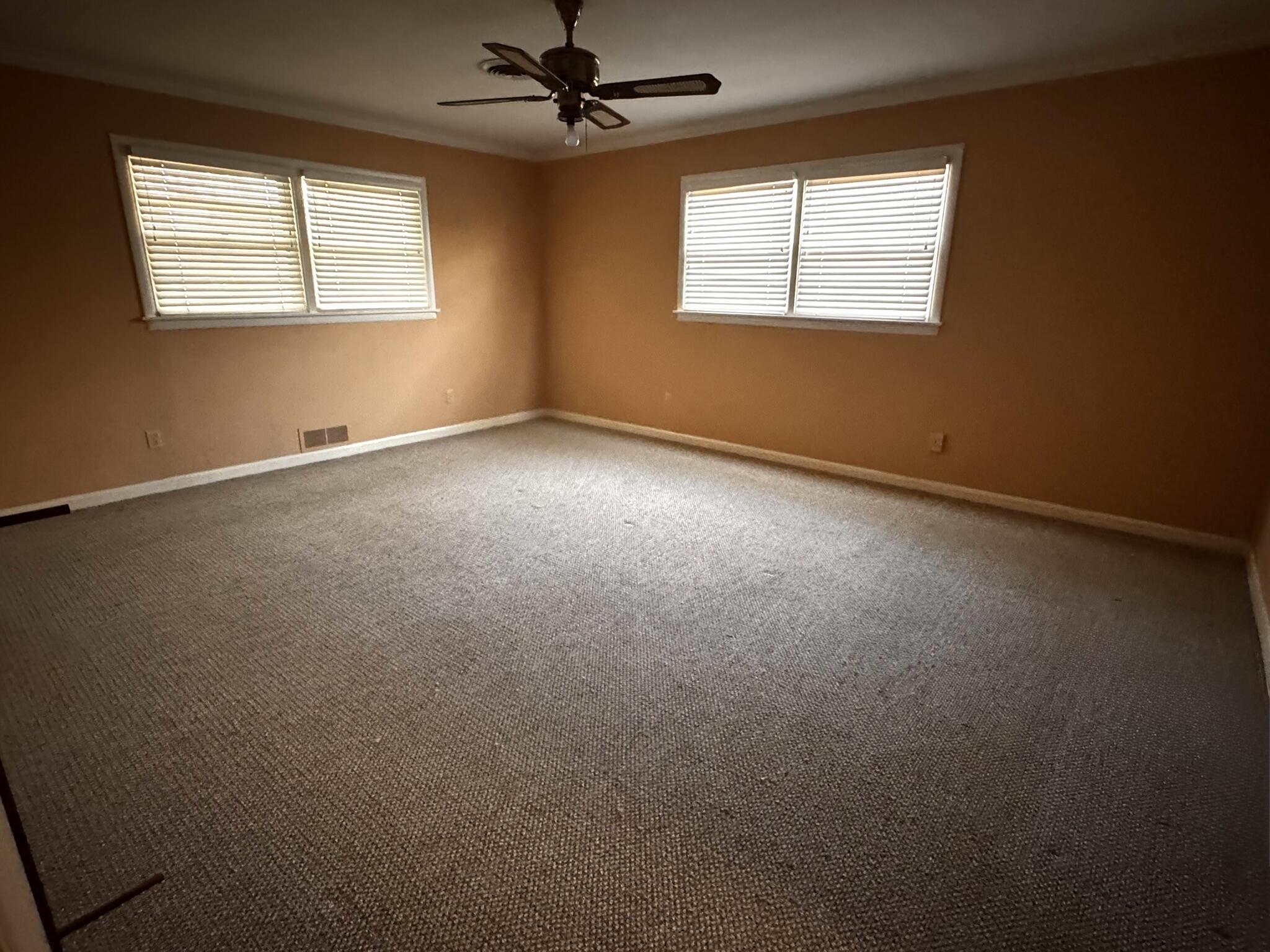 701 Zephyr Plainview, TX 79072 - Photo 19 of 29 an empty room with a window and a fan