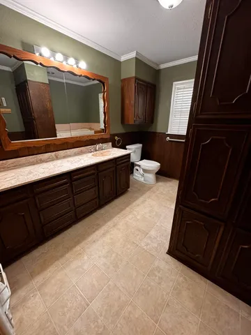 a bathroom with a tub sink and mirror