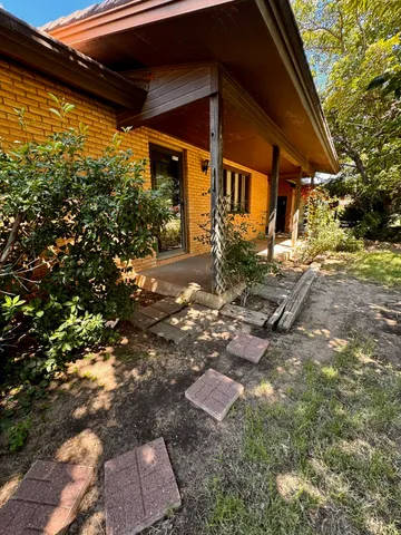 a backyard of a house with yard and outdoor seating