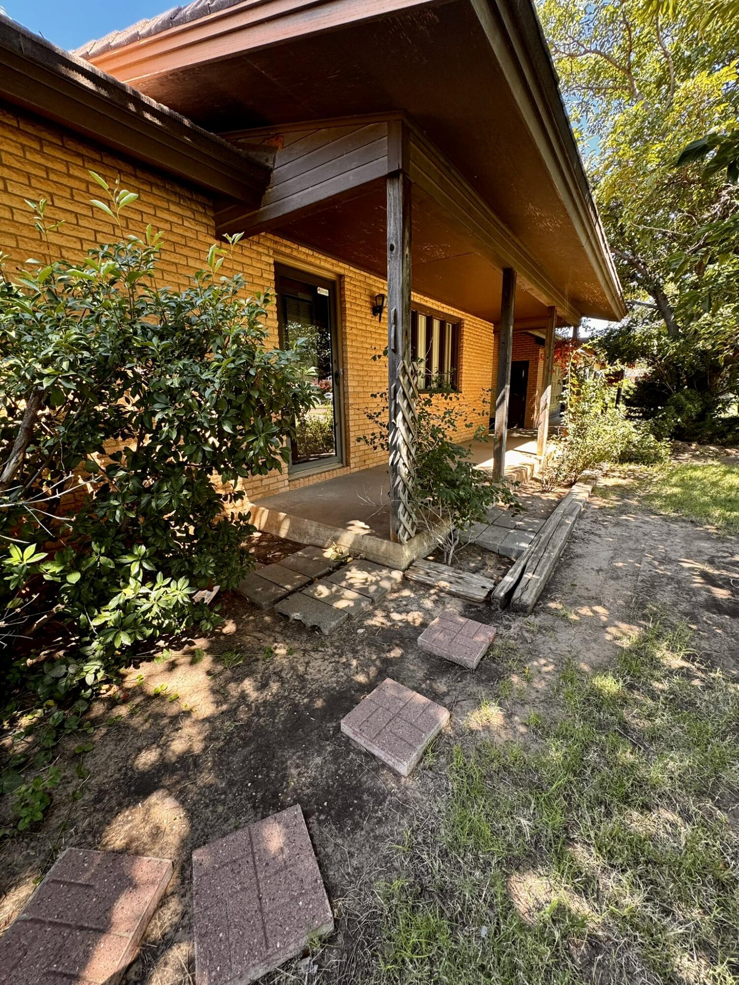 701 Zephyr Plainview, TX 79072 - Photo 3 of 29 a backyard of a house with yard and outdoor seating