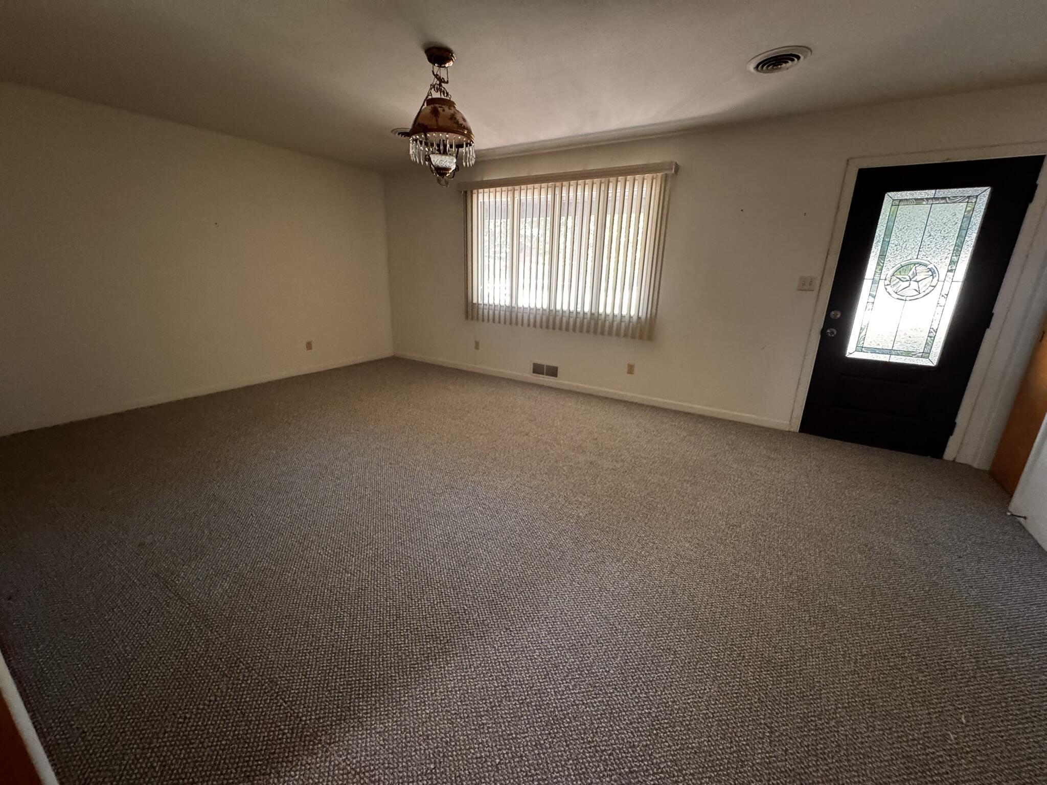 701 Zephyr Plainview, TX 79072 - Photo 7 of 29 a view of an empty room with a window