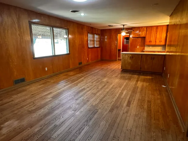 wooden floor in an empty room with a window