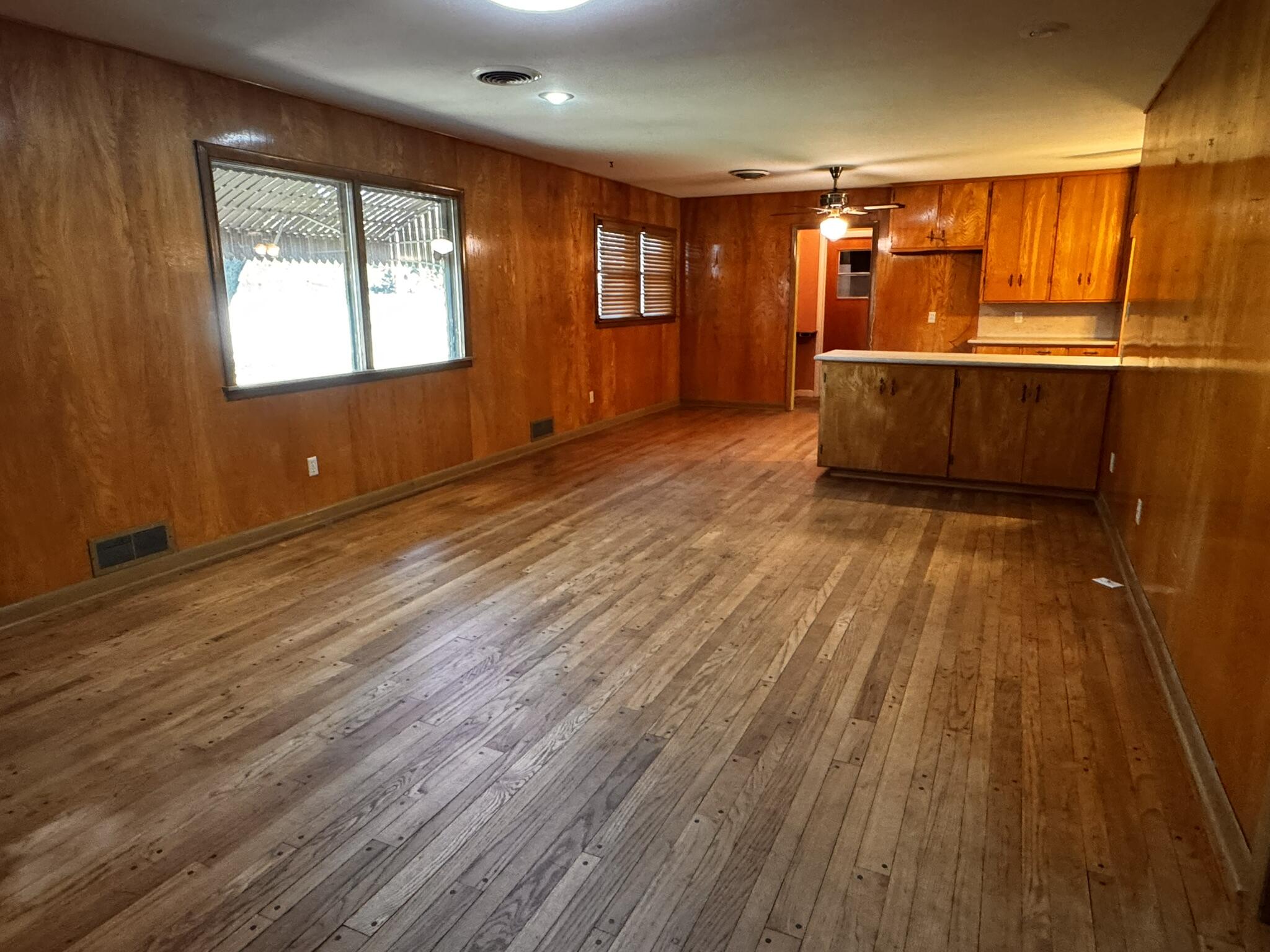 701 Zephyr Plainview, TX 79072 - Photo 8 of 29 wooden floor in an empty room with a window