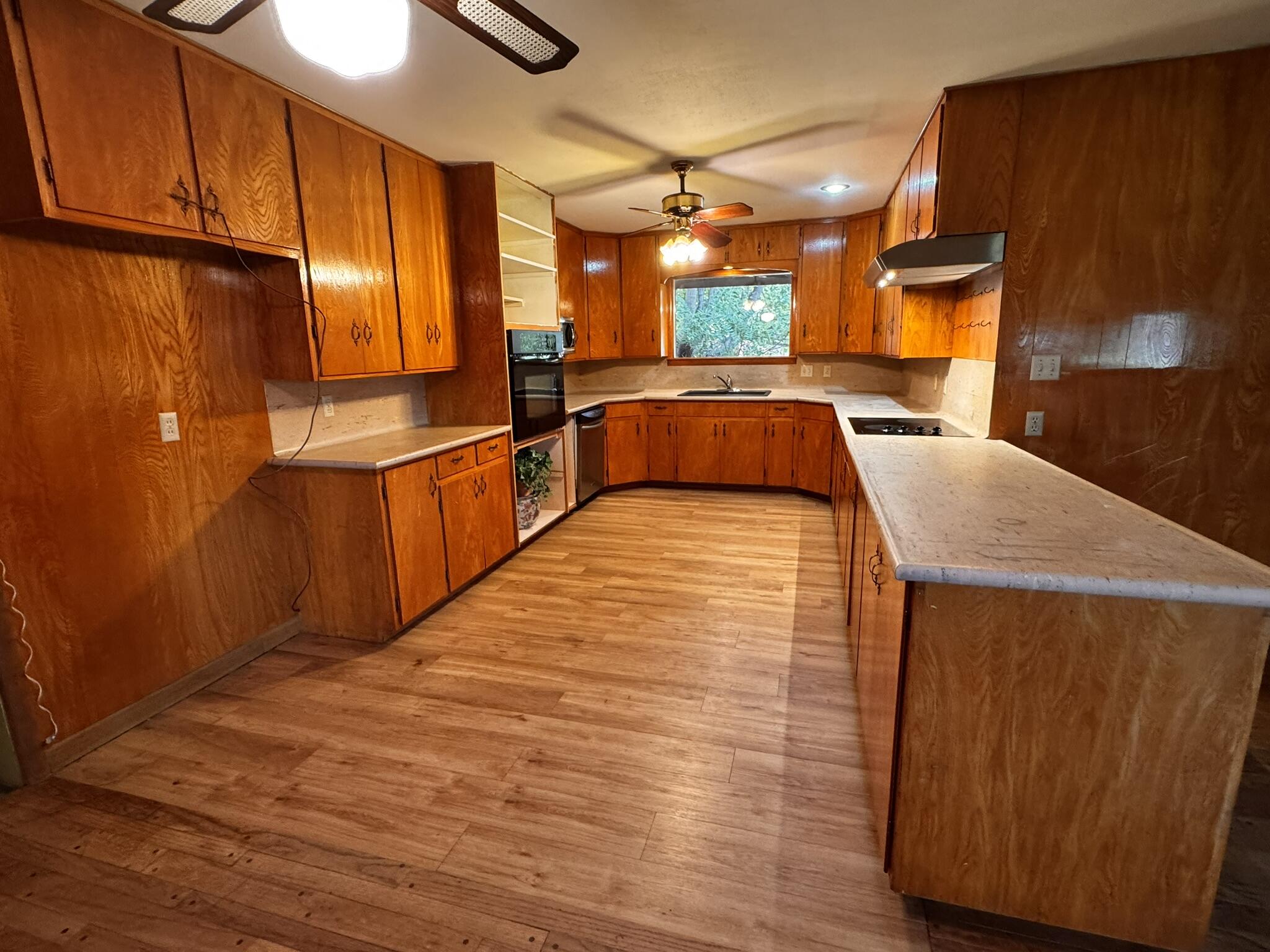 701 Zephyr Plainview, TX 79072 - Photo 9 of 29 a large kitchen with stainless steel appliances wooden floor and a refrigerator