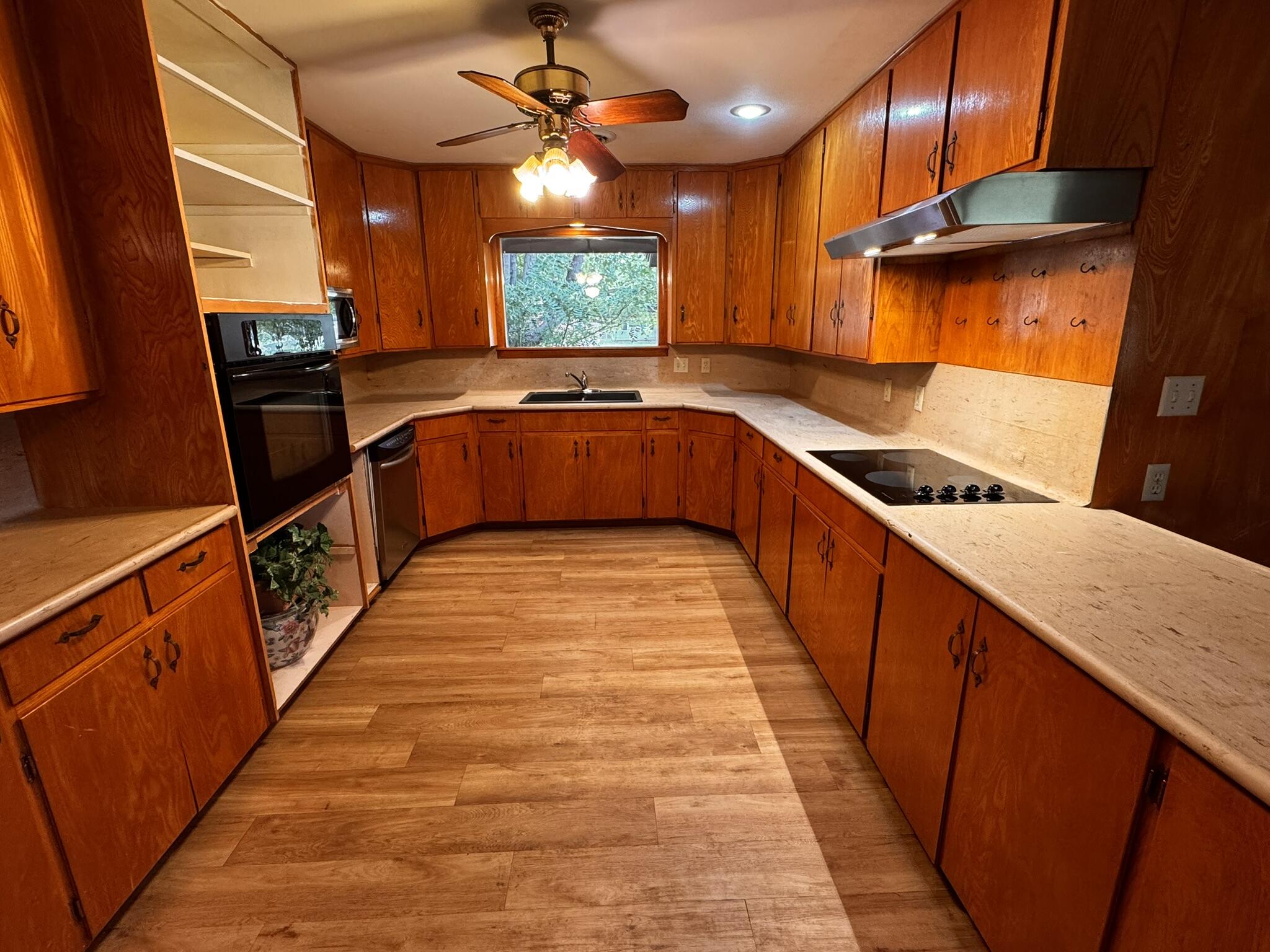 701 Zephyr Plainview, TX 79072 - Photo 10 of 29 a kitchen with granite countertop a sink a counter top space and stainless steel appliances