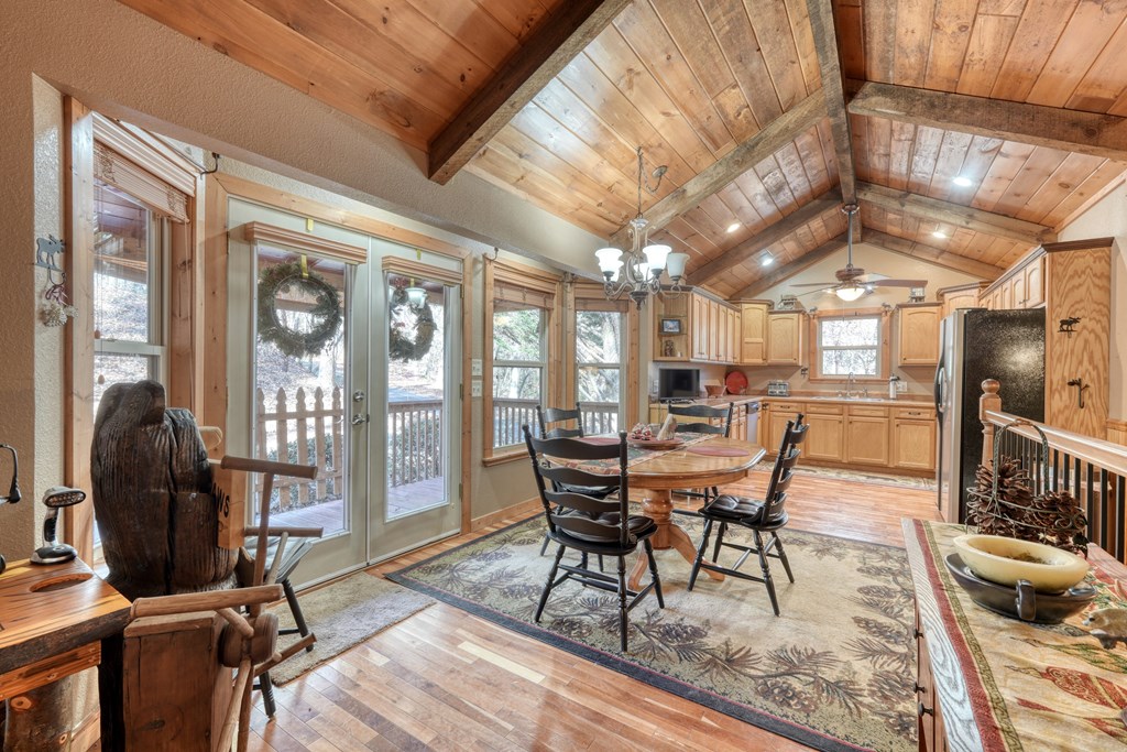 518 Rizzitello Lane Blairsville, GA 30512 - Photo 11 of 44 a dining room with furniture a chandelier and wooden floor