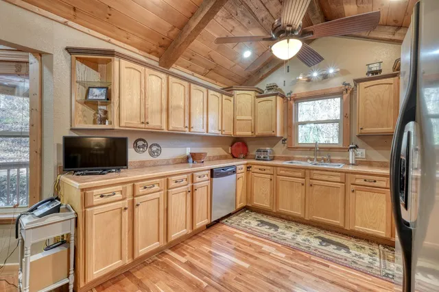a kitchen with granite countertop stainless steel appliances a stove sink and microwave