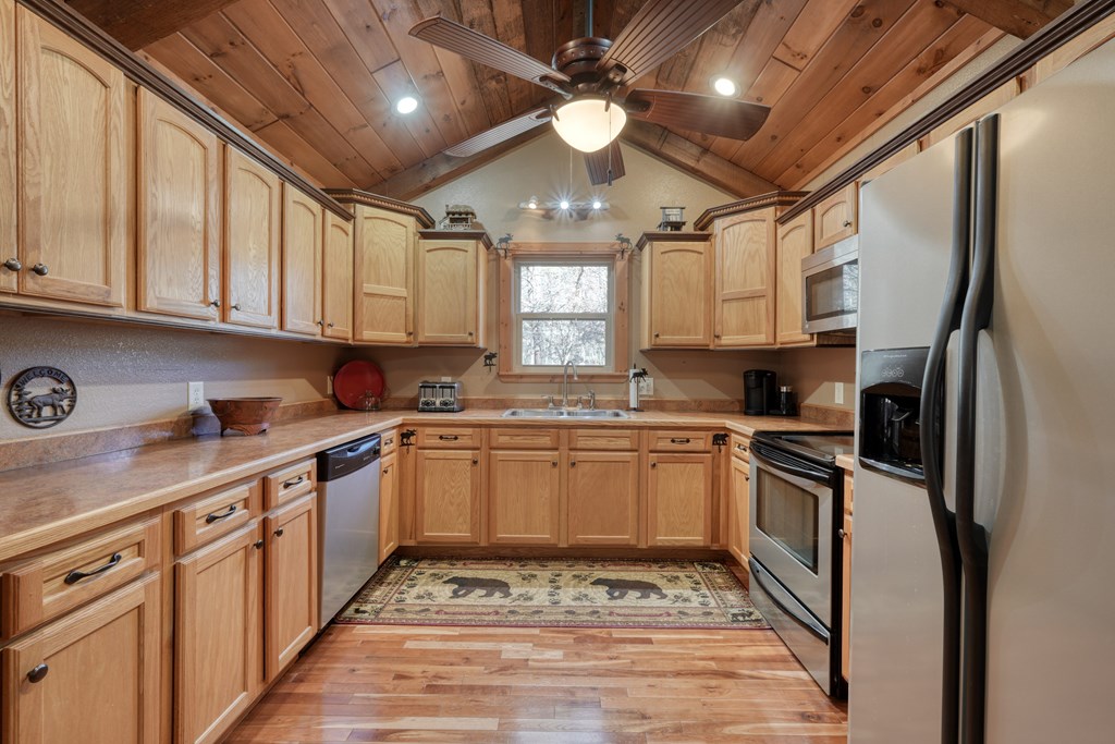 518 Rizzitello Lane Blairsville, GA 30512 - Photo 14 of 44 a kitchen with granite countertop stainless steel appliances a stove sink and microwave