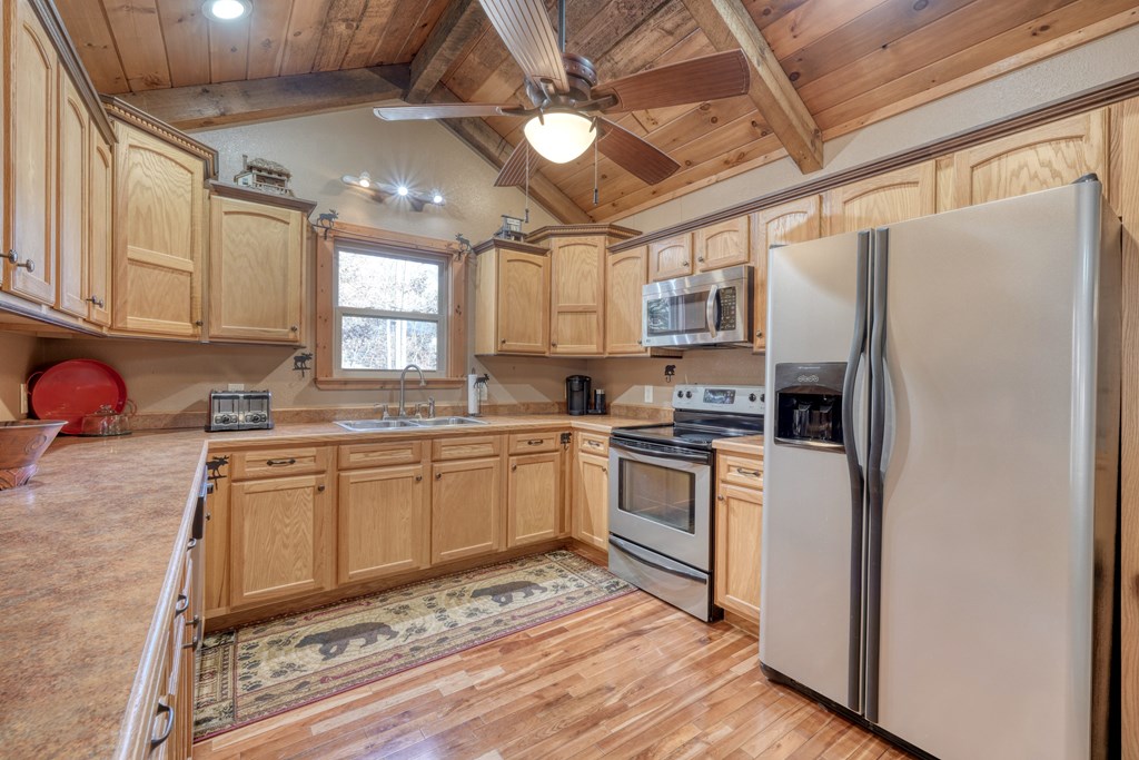 518 Rizzitello Lane Blairsville, GA 30512 - Photo 15 of 44 a kitchen with stainless steel appliances granite countertop a refrigerator a sink dishwasher a stove with white cabinets and wooden floor