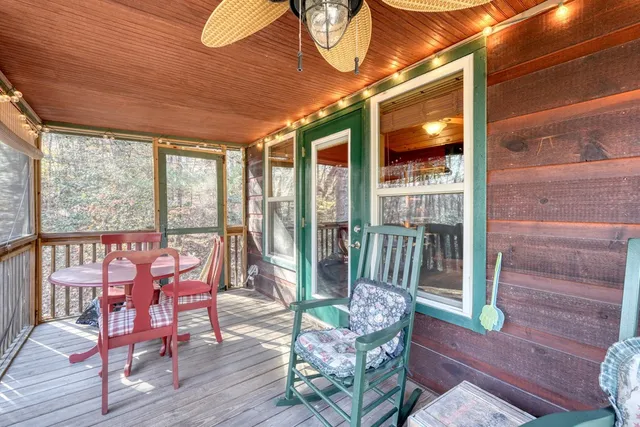 a view of a porch with furniture and a yard