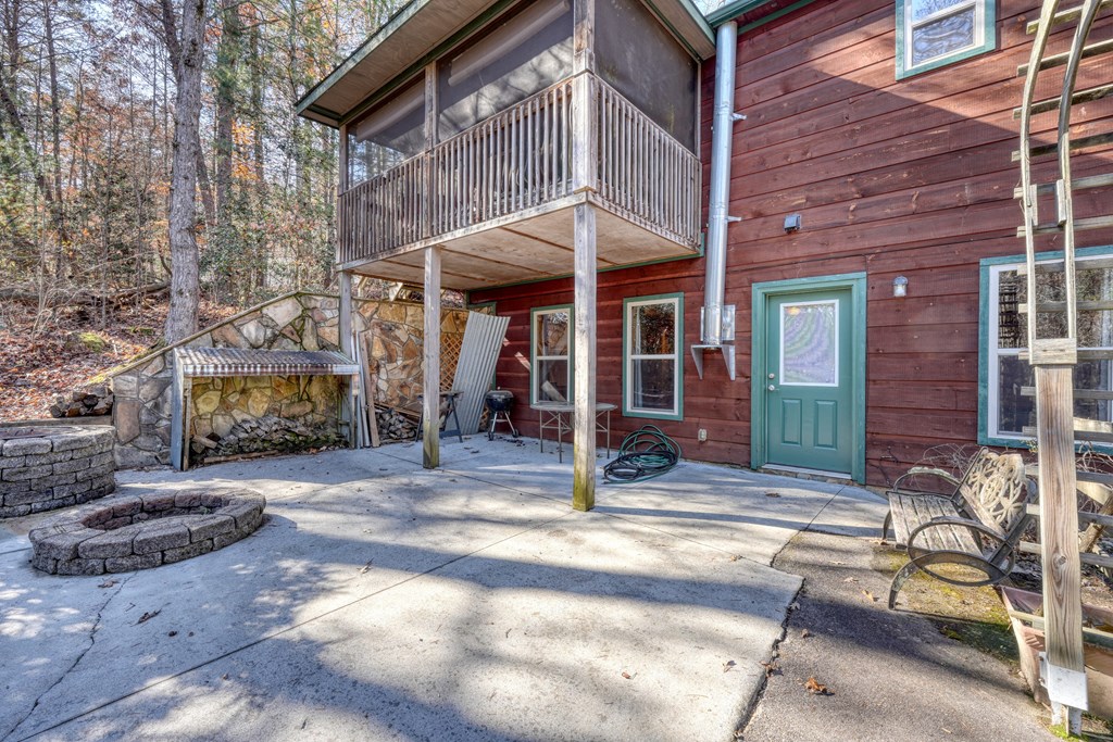 518 Rizzitello Lane Blairsville, GA 30512 - Photo 36 of 44 a view of a brick house with large windows and a table and chairs