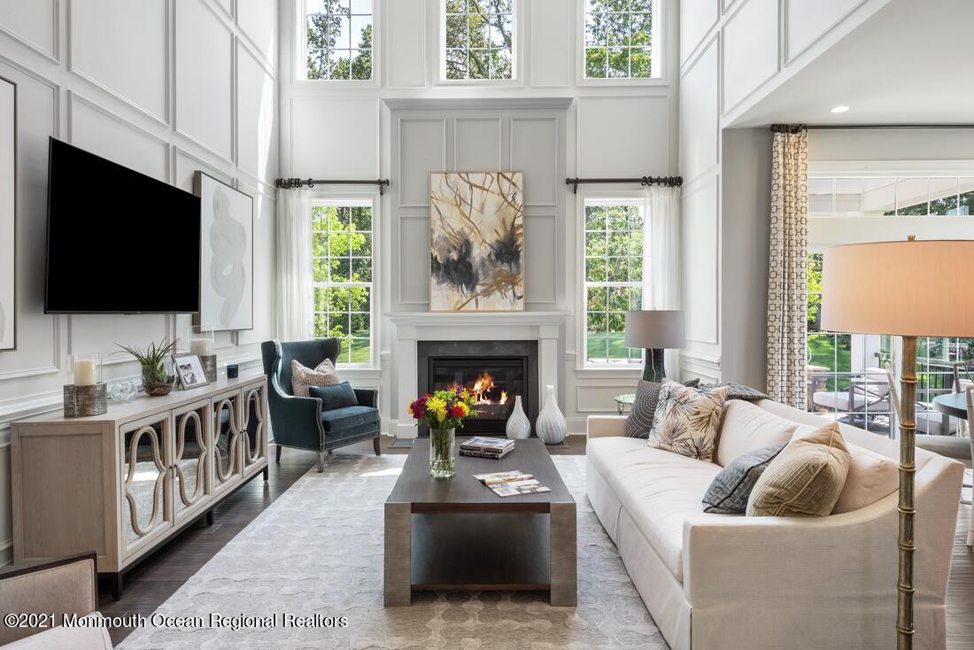 5 Old Eagle Road Freehold, NJ 07728 - Photo 5 of 17 a living room with furniture a flat screen tv and a fireplace