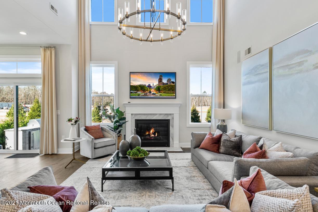 5 Old Eagle Road Freehold, NJ 07728 - Photo 8 of 17 a living room with furniture a fireplace and a flat screen tv