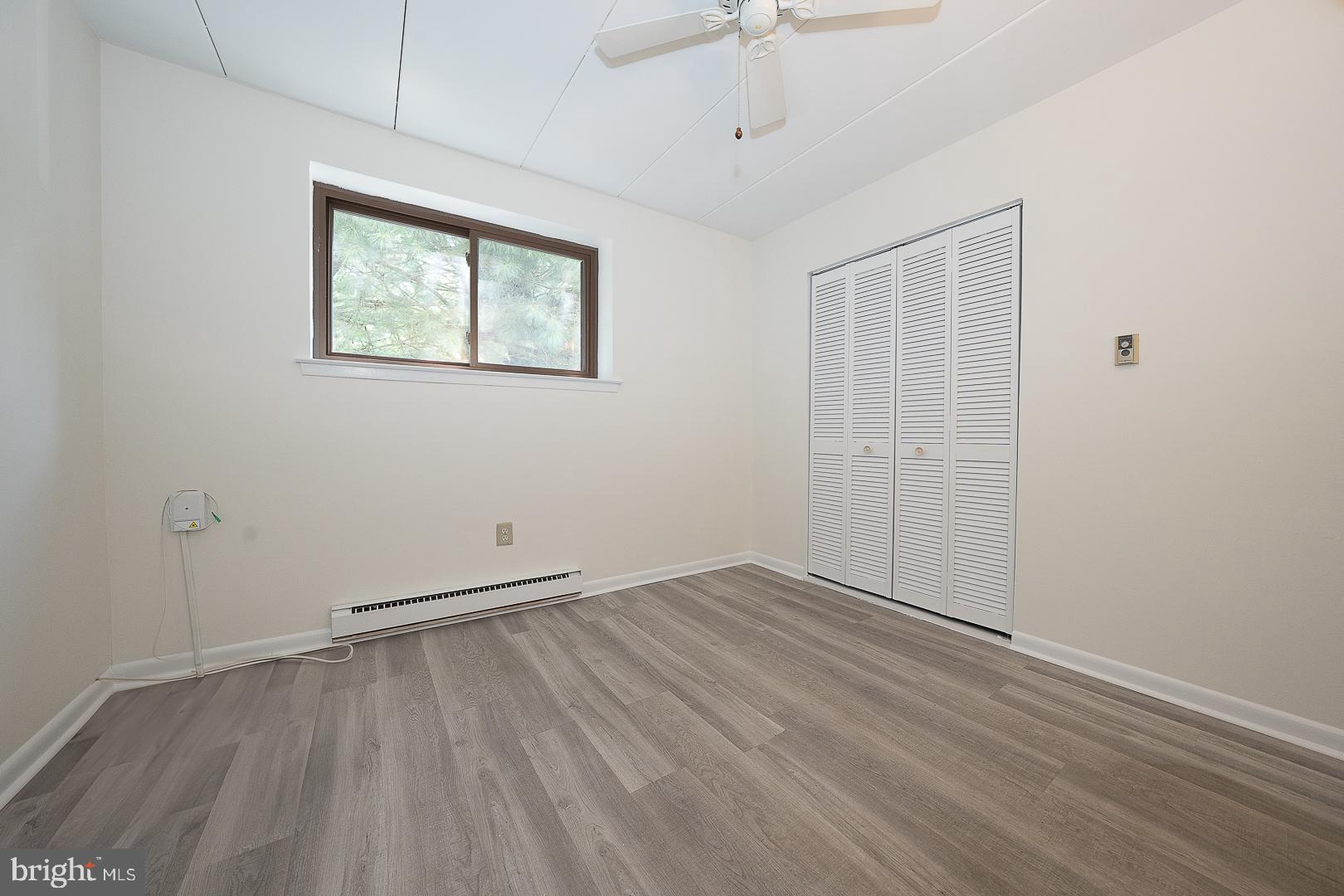 400 Glendale Road, Unit 44 Havertown, PA 19083 - Photo 14 of 29 a view of an empty room with wooden floor and a window