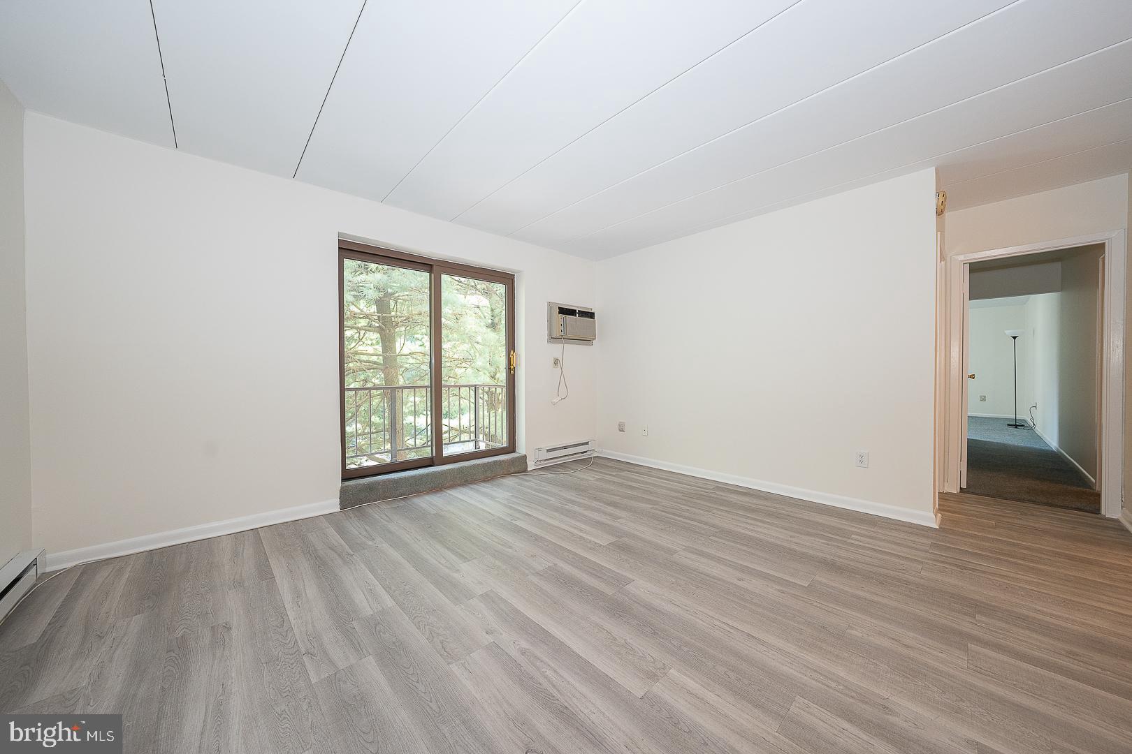 400 Glendale Road, Unit 44 Havertown, PA 19083 - Photo 4 of 29 a view of an empty room with wooden floor and a window