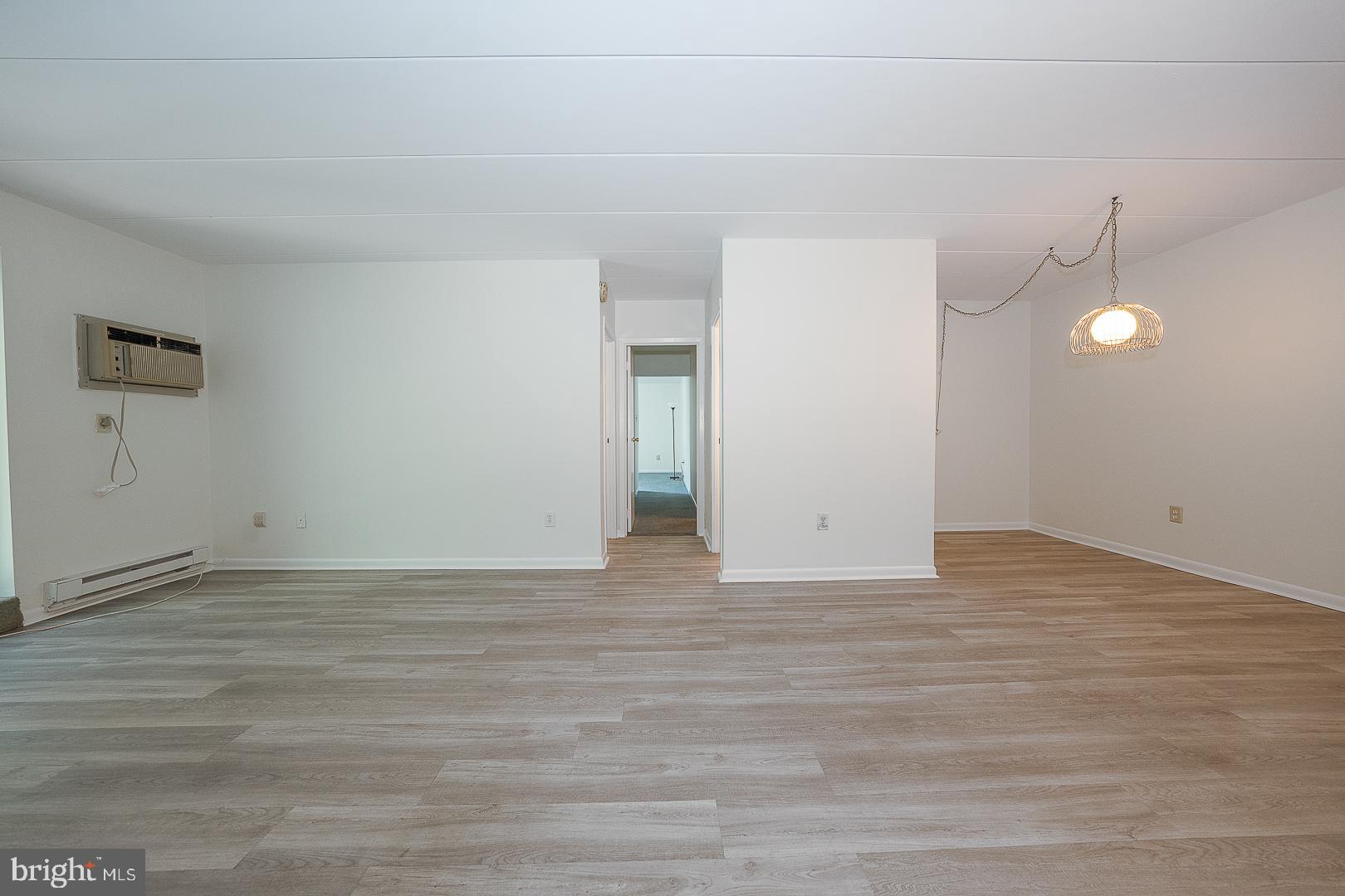 400 Glendale Road, Unit 44 Havertown, PA 19083 - Photo 6 of 29 a view of an empty room with wooden floor and window