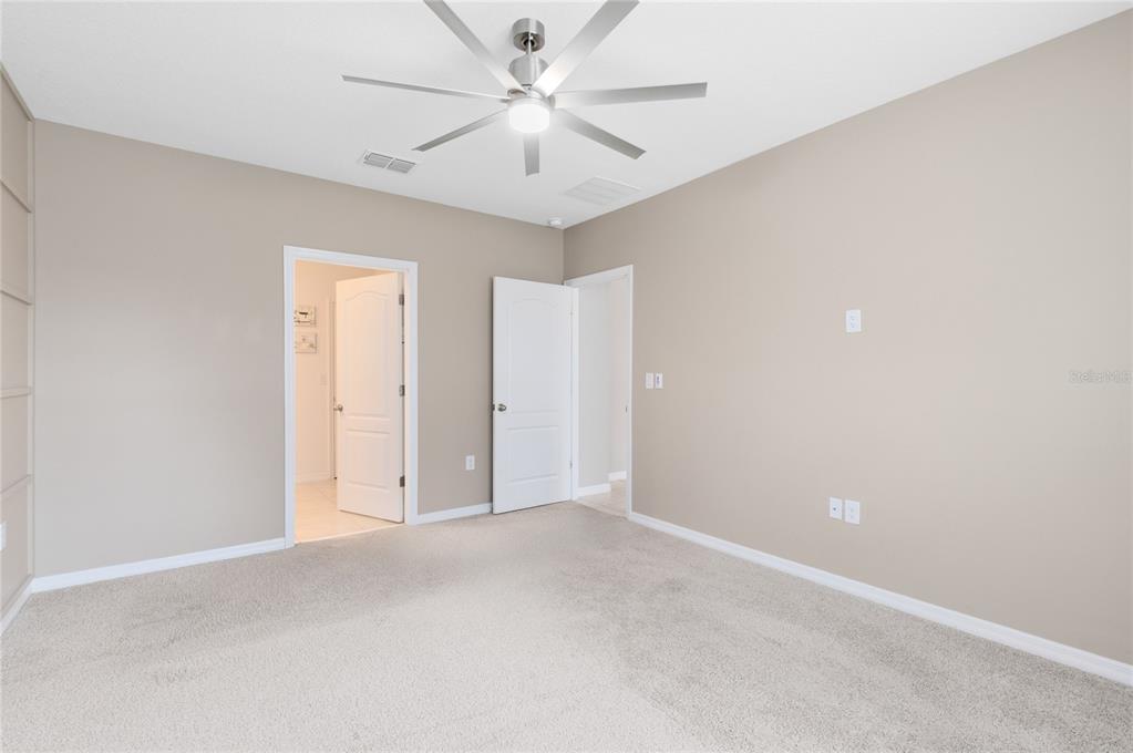 1600 Spray Terrace St. Cloud, FL 34771 - Photo 11 of 30 an empty room with a ceiling fan and a window