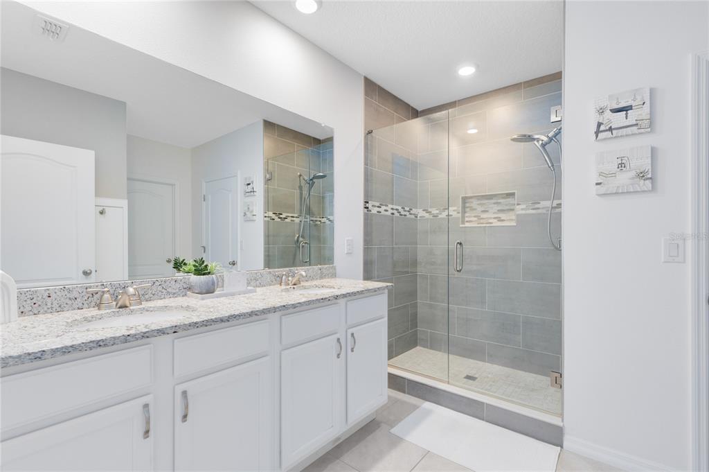 1600 Spray Terrace St. Cloud, FL 34771 - Photo 12 of 30 a bathroom with a shower sink vanity granite and a mirror