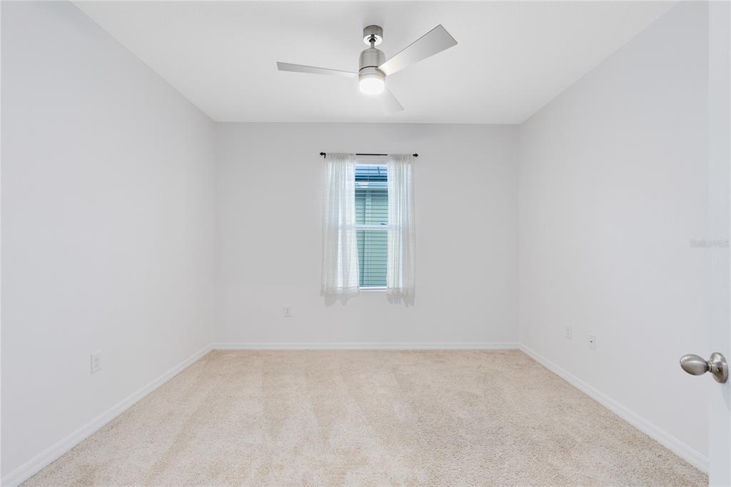 1600 Spray Terrace St. Cloud, FL 34771 - Photo 18 of 30 an empty room with a window and a ceiling fan
