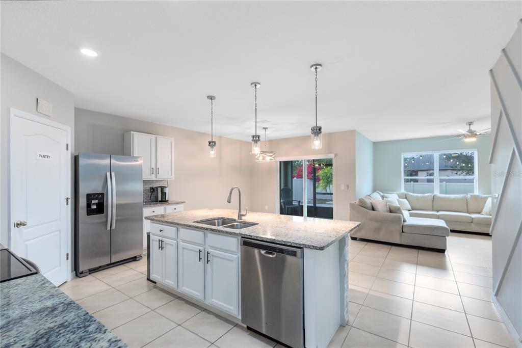 1600 Spray Terrace St. Cloud, FL 34771 - Photo 5 of 30 a kitchen with a sink stove and cabinets
