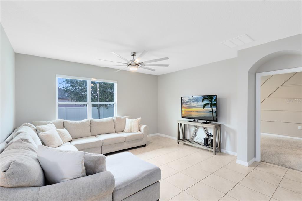 1600 Spray Terrace St. Cloud, FL 34771 - Photo 8 of 30 a living room with furniture and a flat screen tv