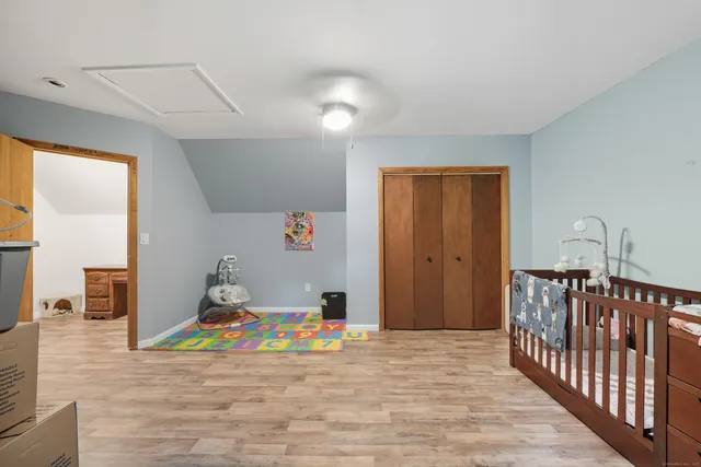 a view of a livingroom with wooden floor and staircase