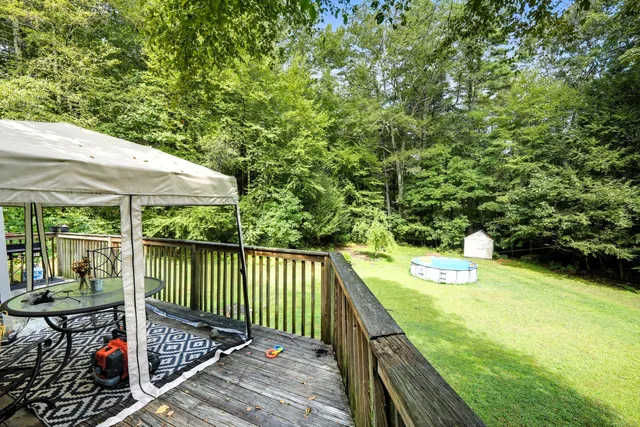 a balcony with wooden floor and outdoor seating