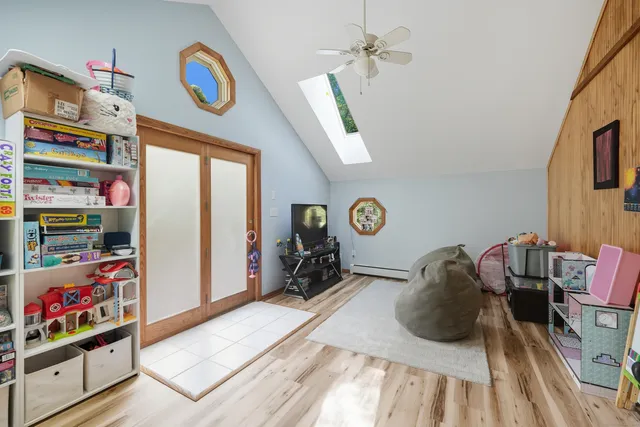 a bed room with a bed a flat screen tv and a window