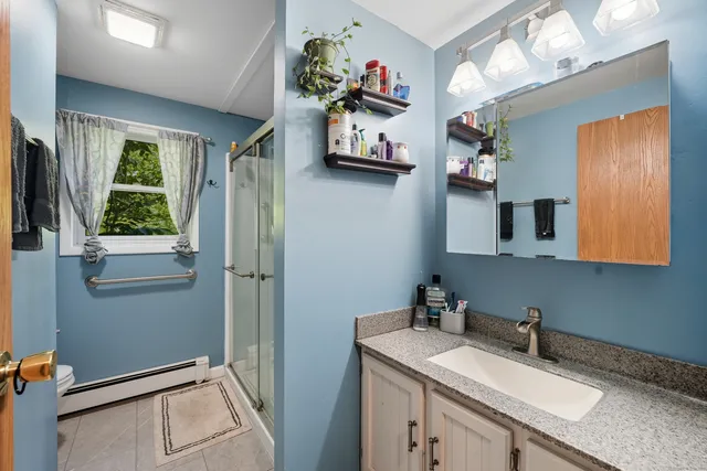 a bathroom with a sink vanity and mirror