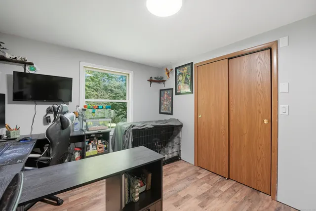a livingroom with workspace and a window