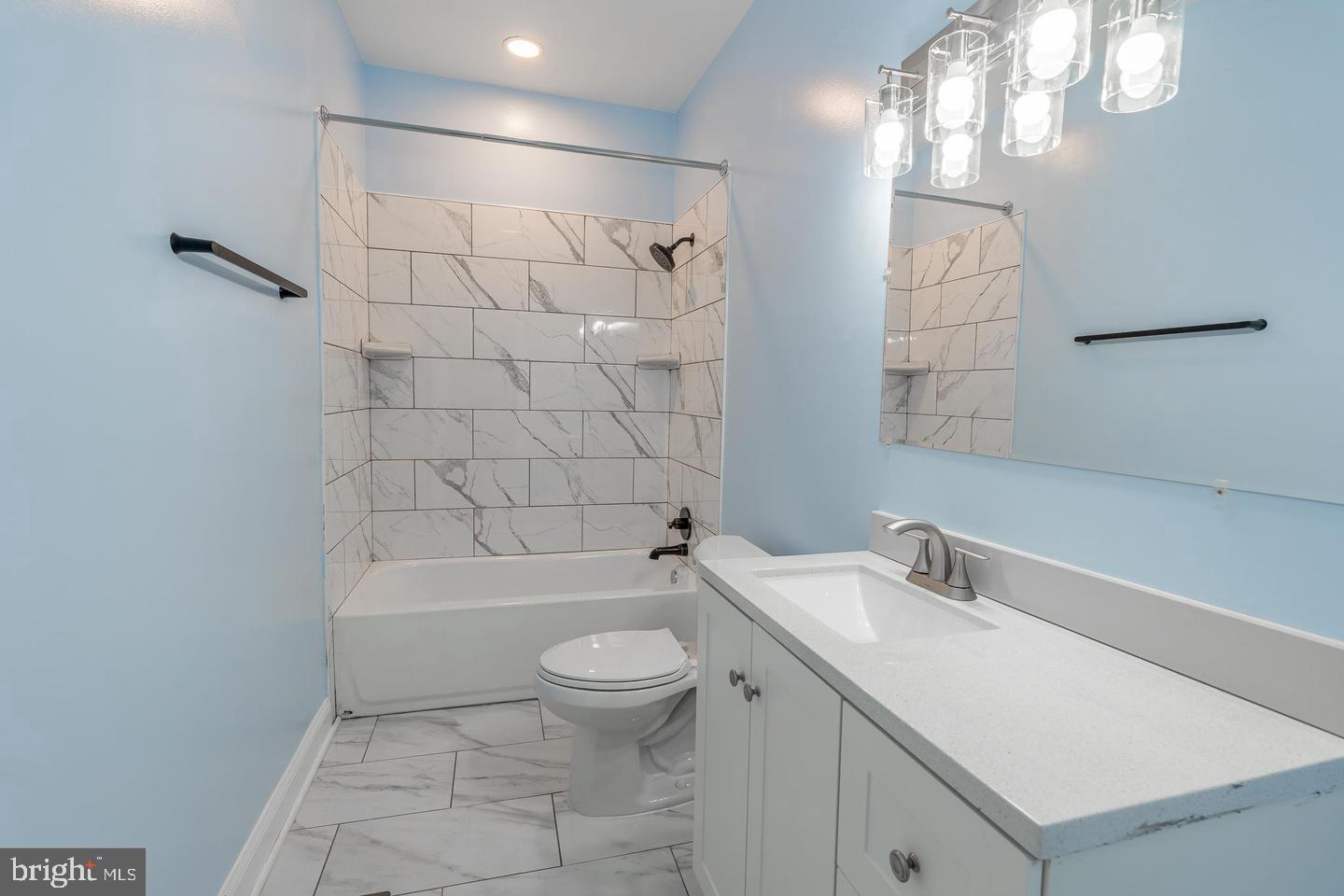 3211 Baker Street Baltimore, MD 21216 - Photo 14 of 20 a bathroom with a sink a toilet and shower