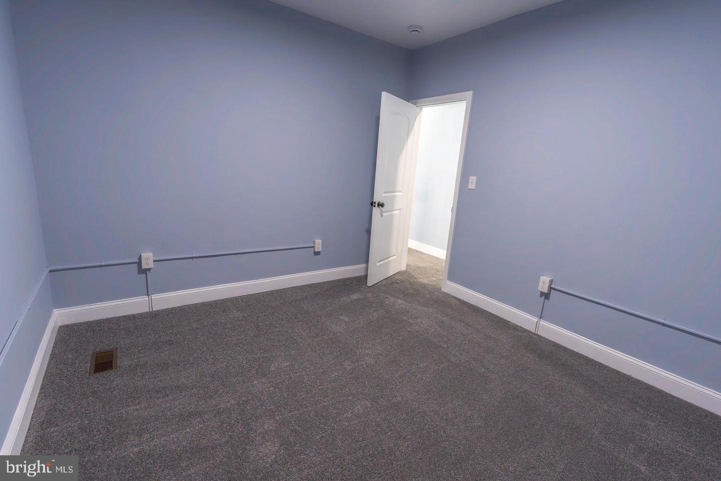 3211 Baker Street Baltimore, MD 21216 - Photo 15 of 20 an empty room with an empty space and windows